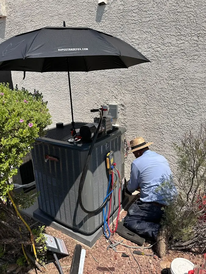 HVAC technician performing outdoor AC maintenance in Marlboro Village